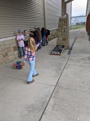 1st grader, Abigail Fuller, playing Cornhole at the 2nd Annual San Saba Showdown. Courtesy of Jessica Fuller