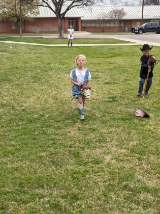 Pre-K student, Lilly Fuller, running in the stick horse races at the 2nd Annual San Saba Showdown. Courtesy of Jessica Fuller