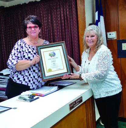 Judge Sharon Blossman presents the Certificate of Election to Alderman Oleta Behrens after the swearing in ceremony.