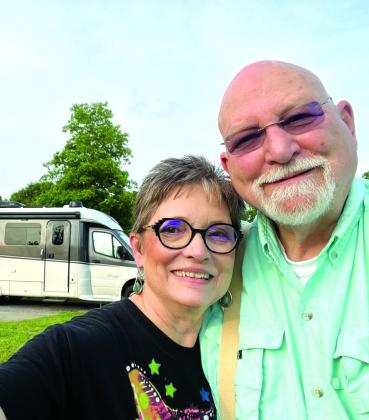 Dr. Craig and Karen Whiting, with their RV, ready to Travel! Photo courtesy of the Whitings